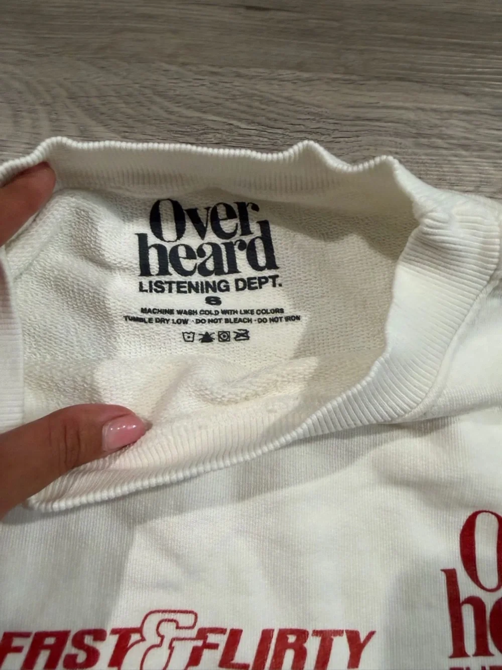 Overheard Flirting Dept. White Crewneck Sweatshirt with Red Graphics